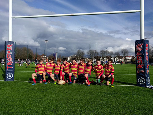 Under-11 rugby team members posing after a rugby match, showcasing their dedication and enthusiasm for the sport
