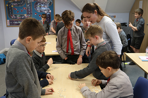 Students playing the word game Bananagrams, demonstrating their vocabulary skills and enjoying a fun and educational activity