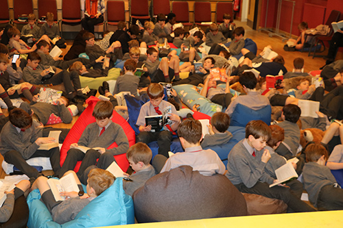 Students participating in a Big Read event, engrossed in reading books and fostering a love for literature