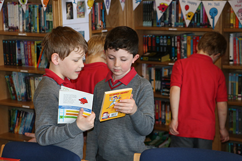 Students participating in a book swap activity, exchanging books and discovering new literary treasures