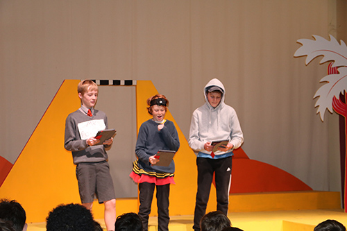 Students showcasing their poetry skills during a Poetry Slam event, expressing creativity and engaging the audience