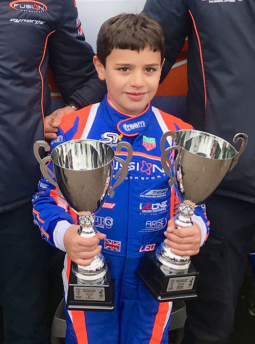 Student named Leo showcasing his awards, reflecting his karting achievements